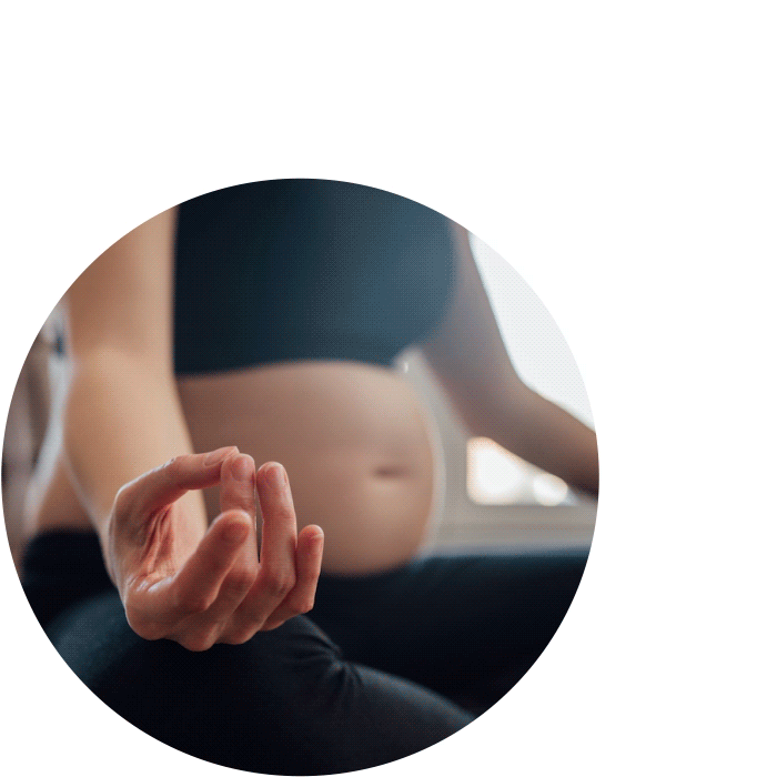 Pregnant woman practicing calmness to represent being calm and in control of finances.